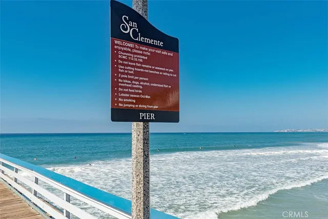 a sign board with wooden fence