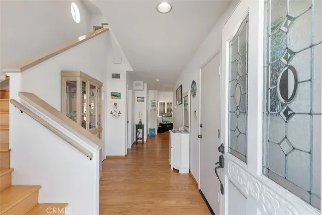 a view of a hallway with wooden floor and staircase