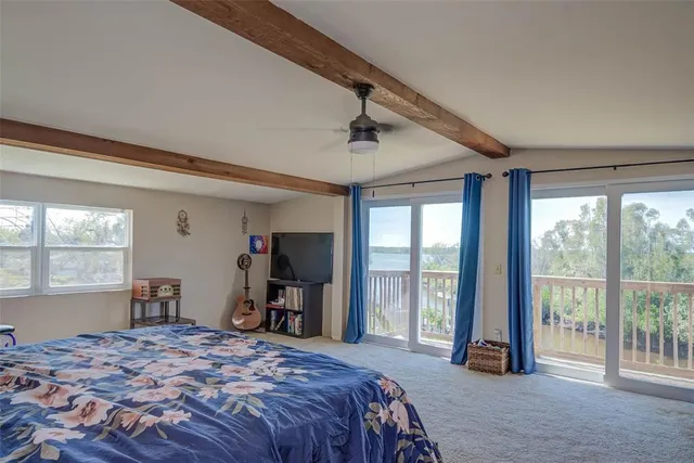 a bedroom with a large bed and a large window