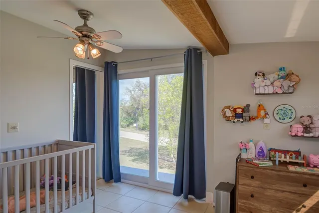 a dining room with wooden floor and chandelier