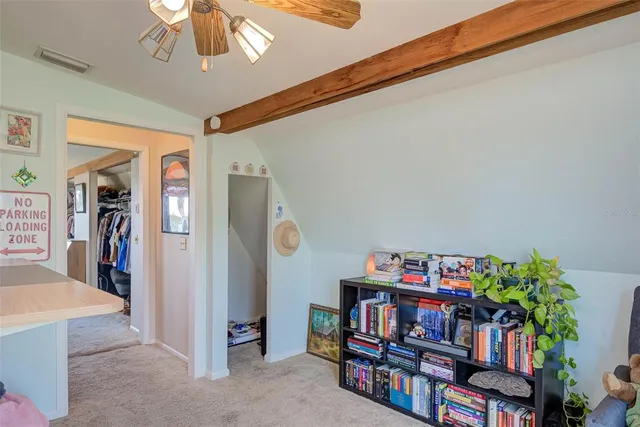 a living room with lots of furniture and a book shelf