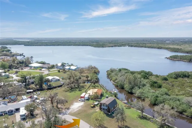 an aerial view of a houses with ocean view
