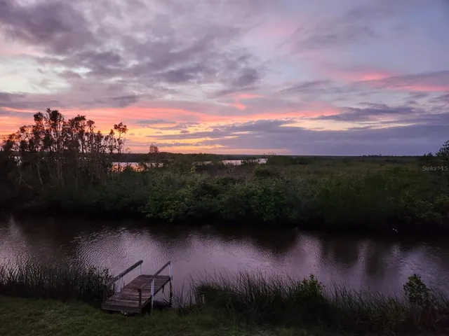 a view of a lake with sunset view