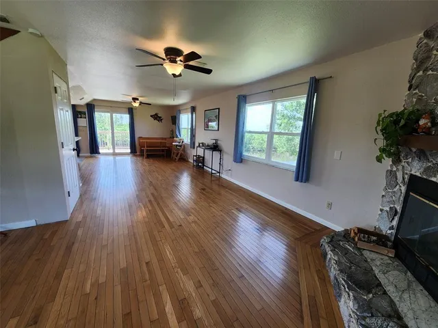 a view of a livingroom with furniture hardwood floor and a window