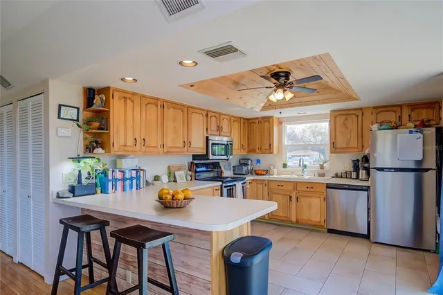 a kitchen with granite countertop a sink appliances and cabinets