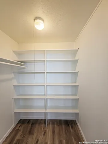 a view of walk in closet with empty racks