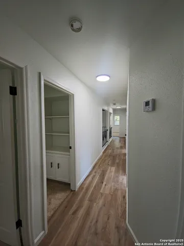 a view of hallway with wooden floor