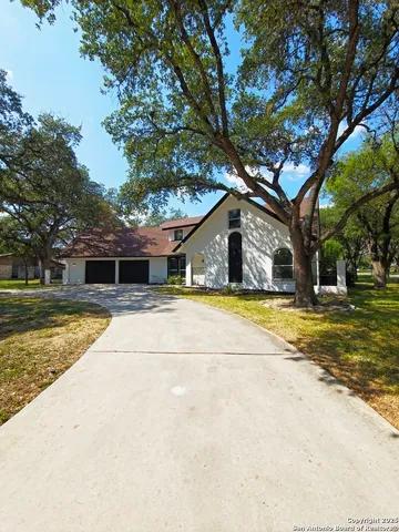 a house view with swimming pool in front of it