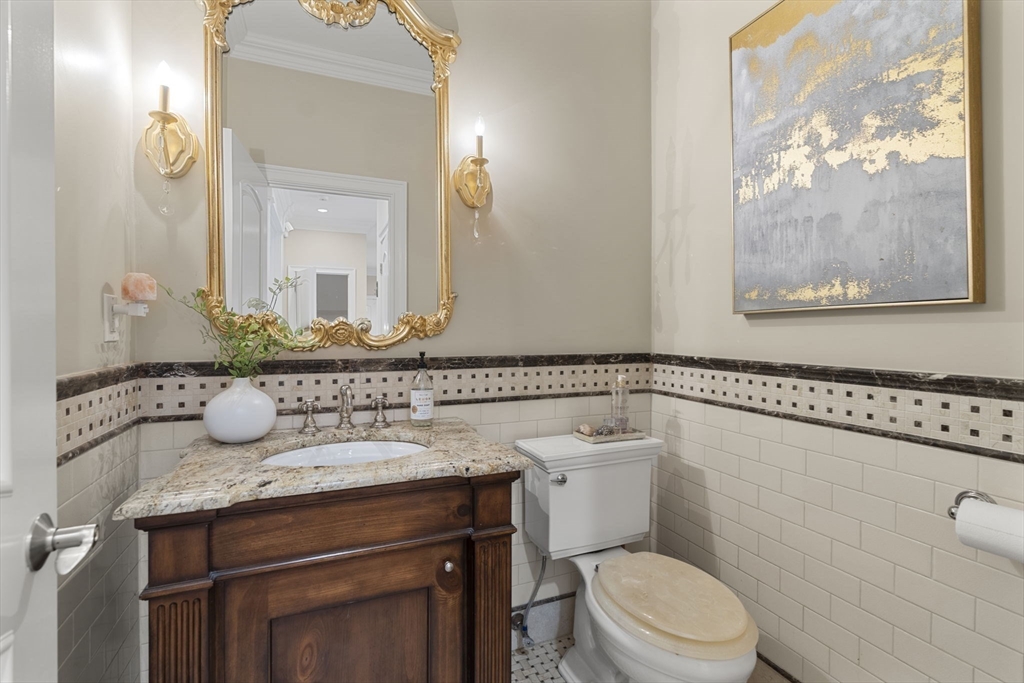 22 Scotney Road Newton, MA 02467 - Photo 39 of 42 a bathroom with a granite countertop toilet sink and mirror