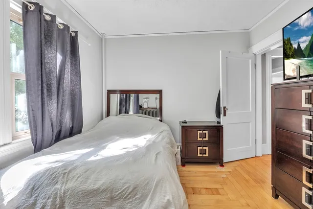 a spacious bedroom with a bed and a television