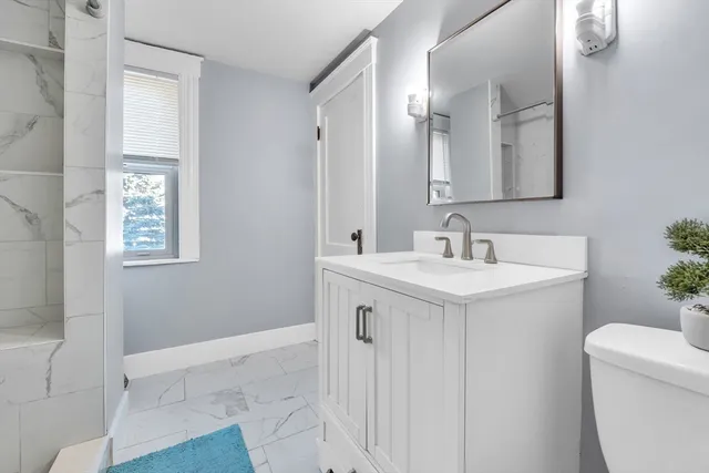 a spacious bathroom with a sink and a mirror