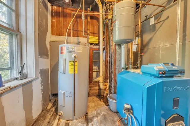 a bathroom with a sink a mirror and next to a window