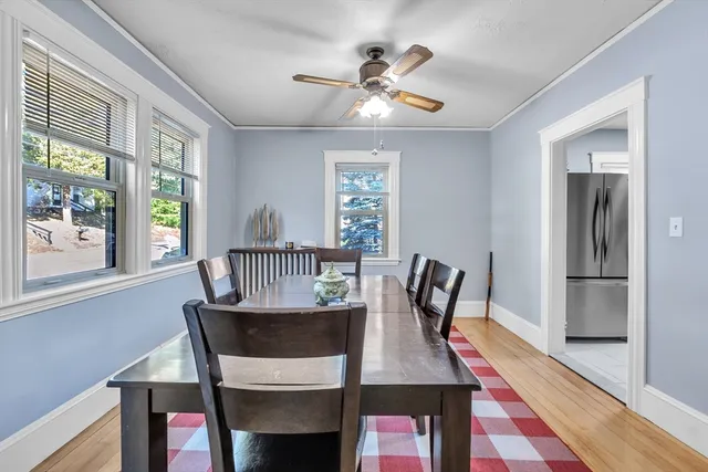 a view of a dining room with furniture and a window