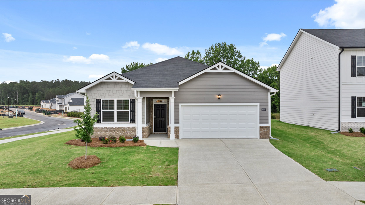 8583 Preakness Pass Snellville, GA 30039 - Photo 1 of 30 a front view of house with yard and green space