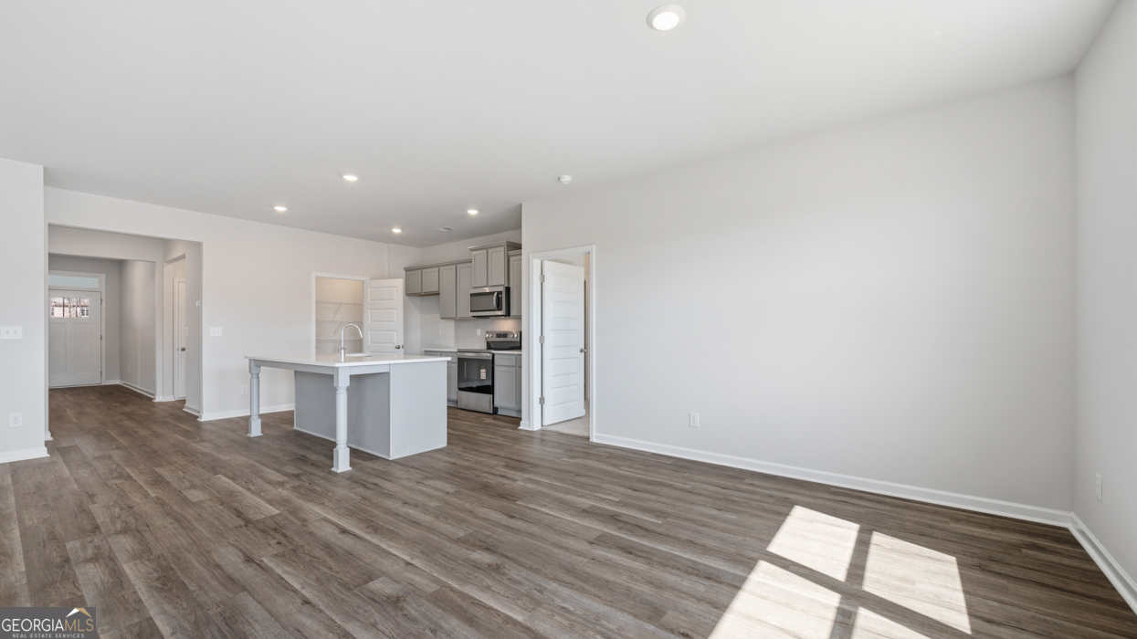 8583 Preakness Pass Snellville, GA 30039 - Photo 11 of 30 a view of kitchen and wooden floor