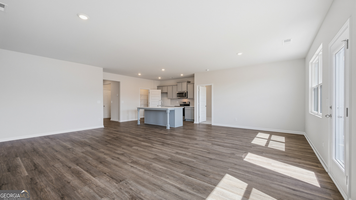 8583 Preakness Pass Snellville, GA 30039 - Photo 21 of 30 a view of kitchen with wooden floor