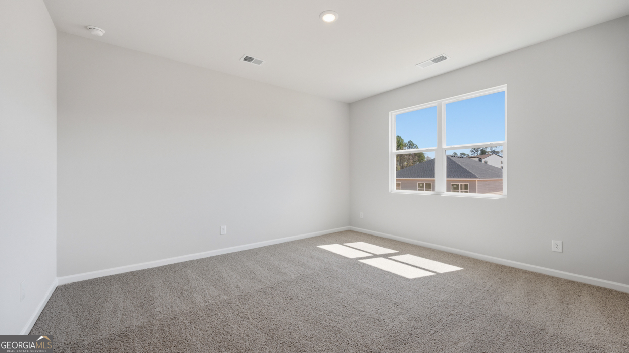 8583 Preakness Pass Snellville, GA 30039 - Photo 23 of 30 an empty room with windows