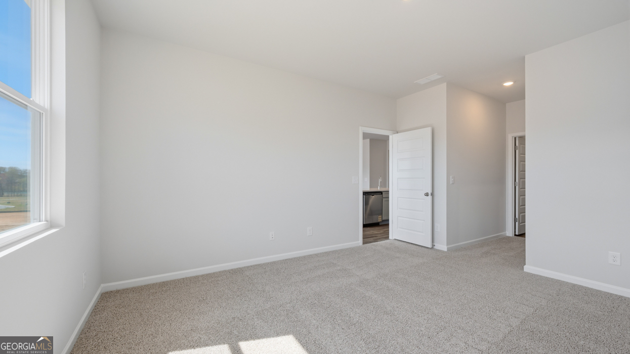 8583 Preakness Pass Snellville, GA 30039 - Photo 24 of 30 a view of an empty room and a window