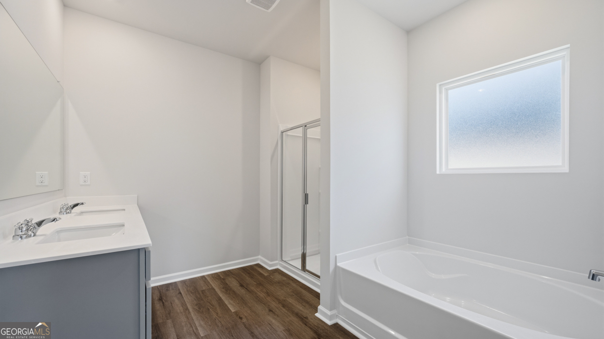 8583 Preakness Pass Snellville, GA 30039 - Photo 25 of 30 a bathroom with a bathtub and a sink