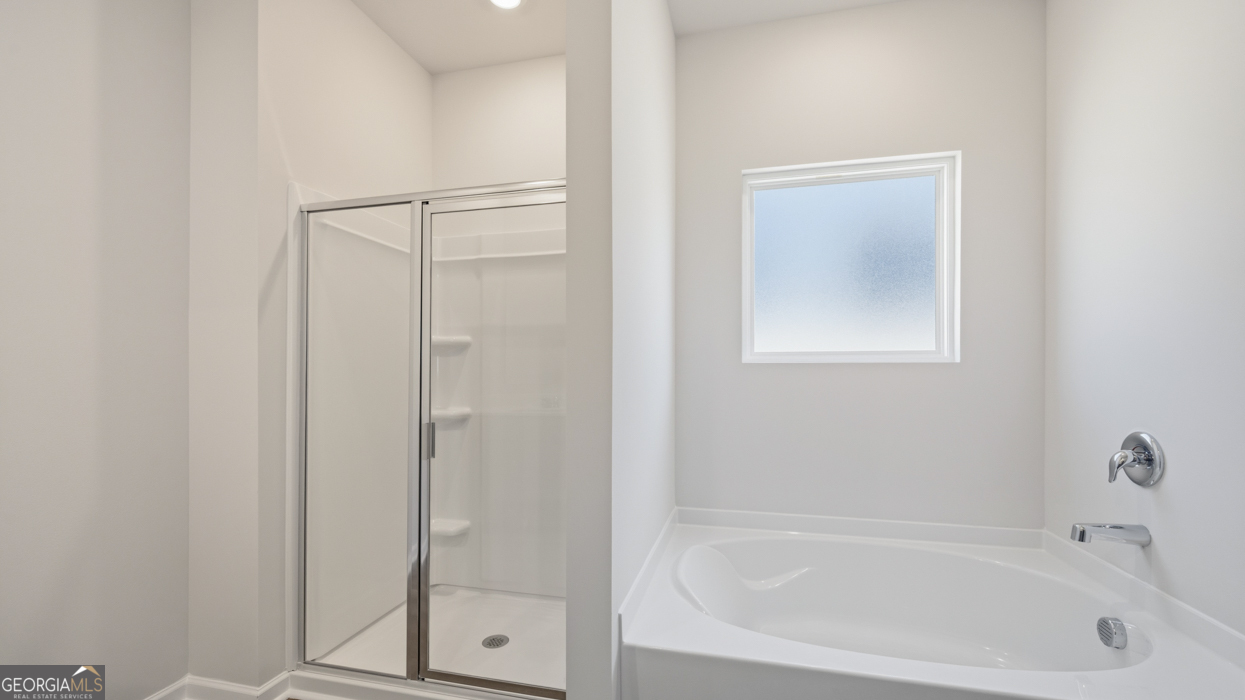 8583 Preakness Pass Snellville, GA 30039 - Photo 26 of 30 a white bath tub sitting next to a shower