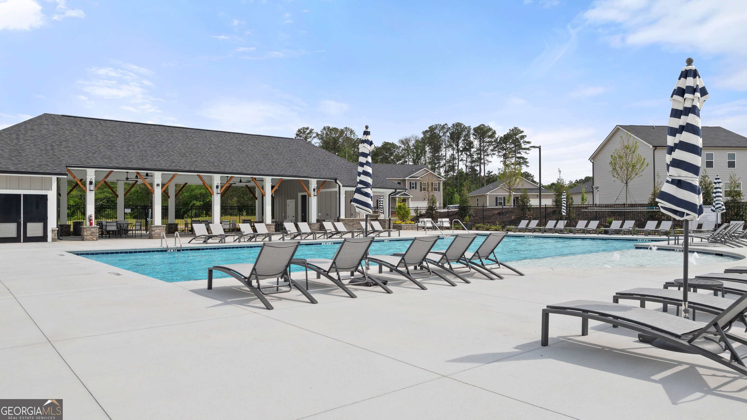 8583 Preakness Pass Snellville, GA 30039 - Photo 28 of 30 a view of a swimming pool with chairs