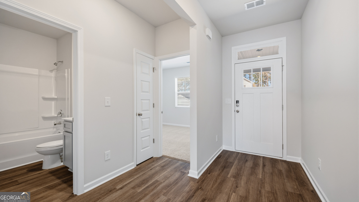 8583 Preakness Pass Snellville, GA 30039 - Photo 3 of 30 a view of a bathroom with wooden floor