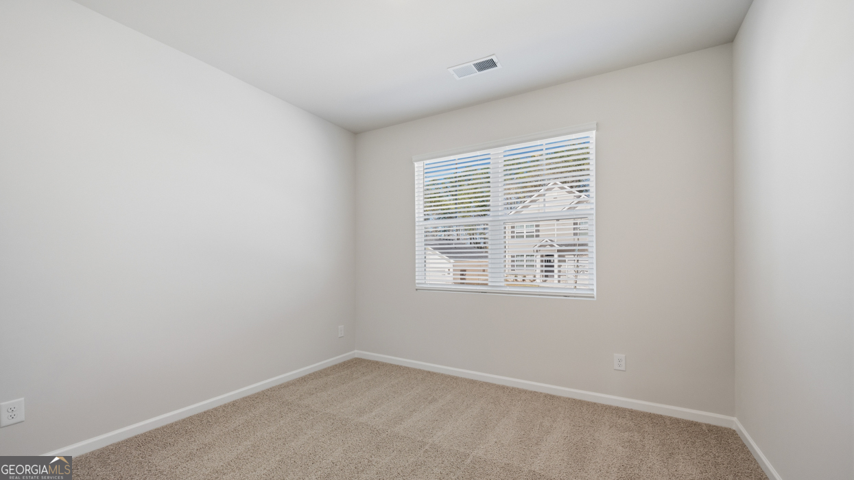 8583 Preakness Pass Snellville, GA 30039 - Photo 4 of 30 an empty room with a window