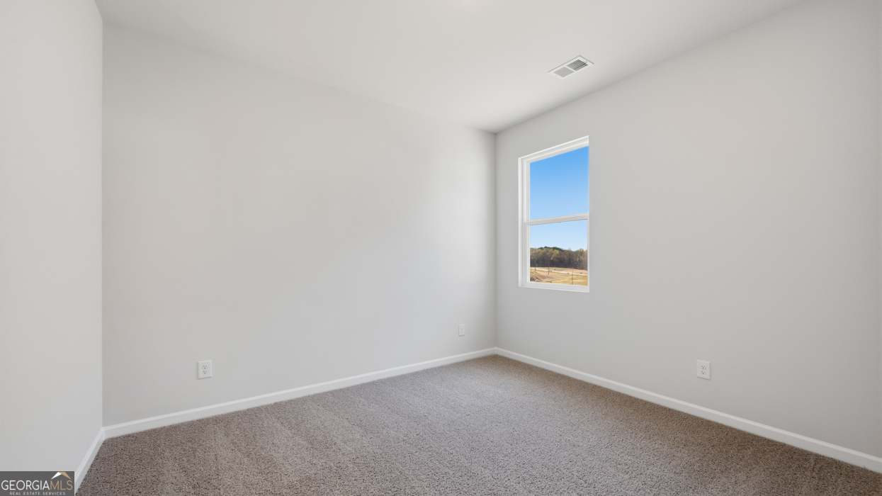 8583 Preakness Pass Snellville, GA 30039 - Photo 6 of 30 a room that has a window in it