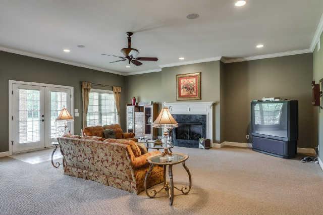 1400 Franklin Road Brentwood, TN 37027 - Photo 14 of 20 Lower level family room with fireplace, ceiling fan and carpet is open to the additional kitchen. The lower level would make a fabulous in-law suite, nanny quarters or living space for an older child who has come back home to live.