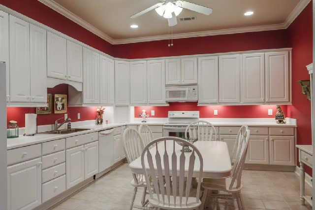 1400 Franklin Road Brentwood, TN 37027 - Photo 15 of 20 This full kitchen is located on the lower level with solid surface cooktop stove, microwave, dishwasher, refrigerator, tile floors and fabulous cabinet storage space.