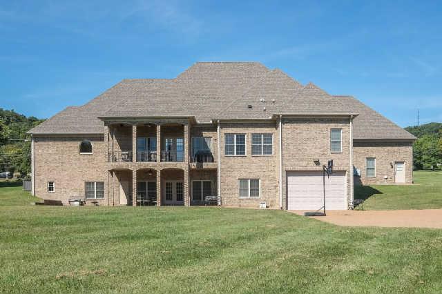 1400 Franklin Road Brentwood, TN 37027 - Photo 19 of 20 View of the back of the house from the back of the 3.04 acre lot. House offers 2 patio areas, 3 garages on the main level, and an oversized garage with 12 foot door on the lower level. Perfect spot for a pool!