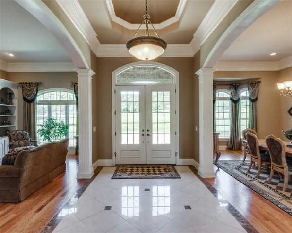 1400 Franklin Road Brentwood, TN 37027 - Photo 2 of 20 Foyer, Formal Living Room, Formal Dining Room all with 12' ceilings*Solid wood front door w/ Palladian window, beautiful marble flooring* LR w/ fireplace, marble surround, custom built-in's*DR w/ bay Palladian window*Detailed moldings on main level