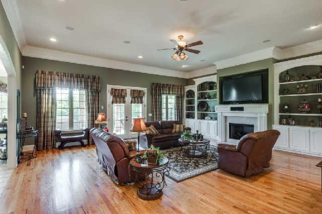 1400 Franklin Road Brentwood, TN 37027 - Photo 3 of 20 Large main level family great room with 12 foot ceilings, hardwoods, fireplace with marble surround, custom built-in's, French doors to patio. Open to the kitchen for perfecting flow for entertaining.