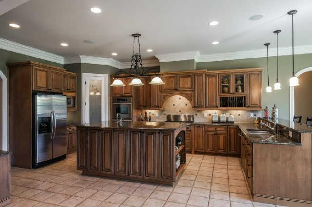 1400 Franklin Road Brentwood, TN 37027 - Photo 5 of 20 Fabulous Omega cabinets in the kitchen w/ stainless Kitchen Aid appliances, double ovens, warming drawer, refrigerator, microwave, gas 6 burner cook top, dishwasher*Raised island, granite countertops, vented hood.