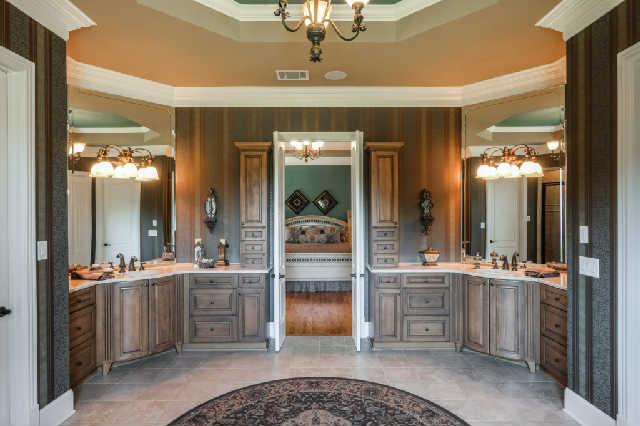 1400 Franklin Road Brentwood, TN 37027 - Photo 9 of 20 Incredible master bath w/ double vanities, tile floors, exceptional cabinet space, marble counter tops, Whirlpool tub, space for a wall mounted television, & beautiful Palladium window. His & her closets complete the master suite.