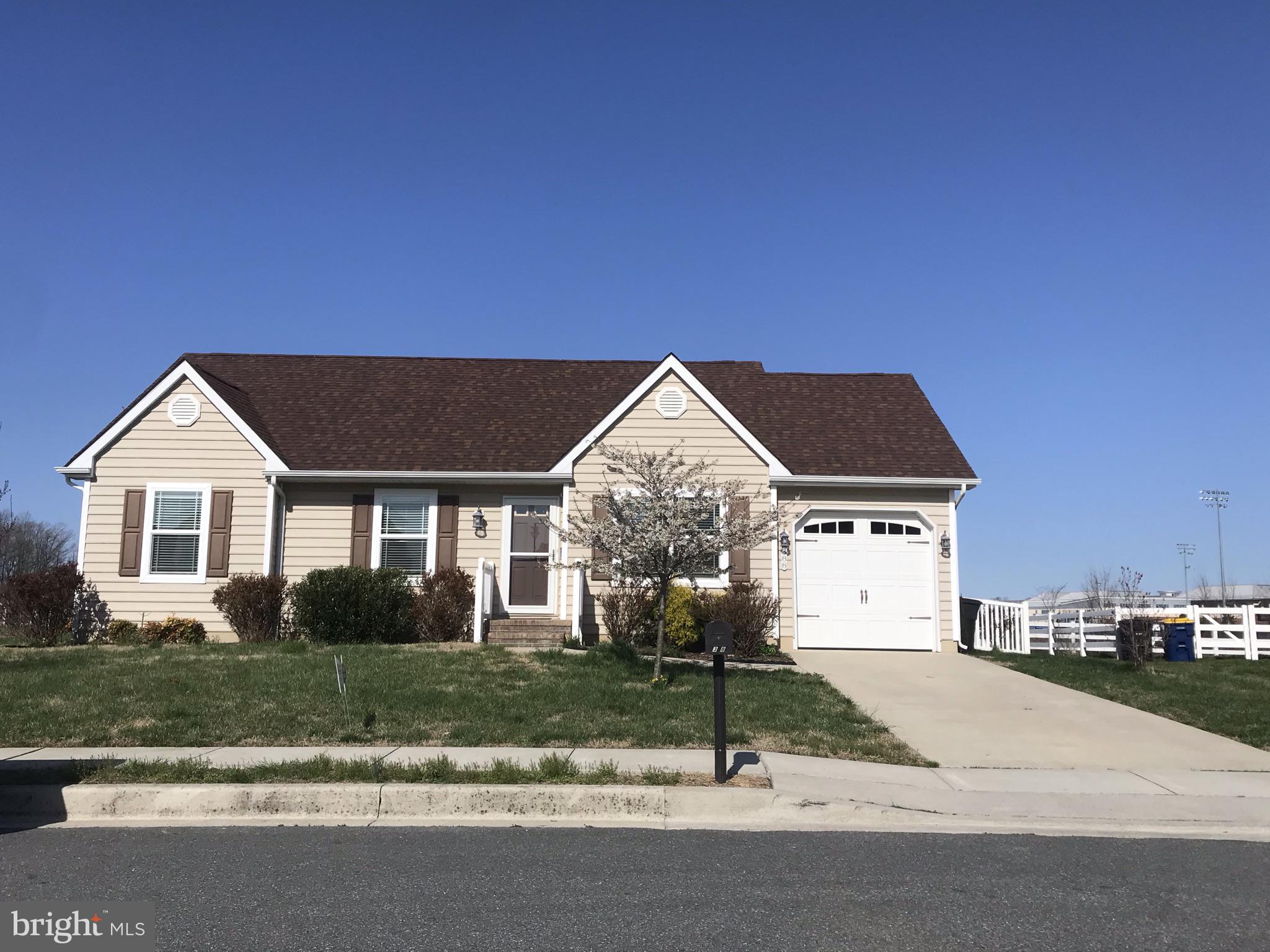 388 Northdown Drive Dover, DE 19904 - Photo 2 of 2 a front view of a house with a yard and garage