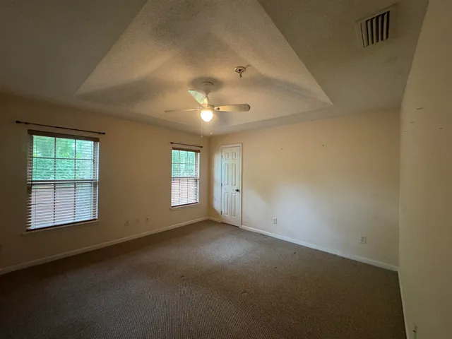 an empty room with a empty space and windows