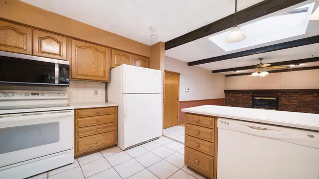 a kitchen with stainless steel appliances a stove microwave and cabinets