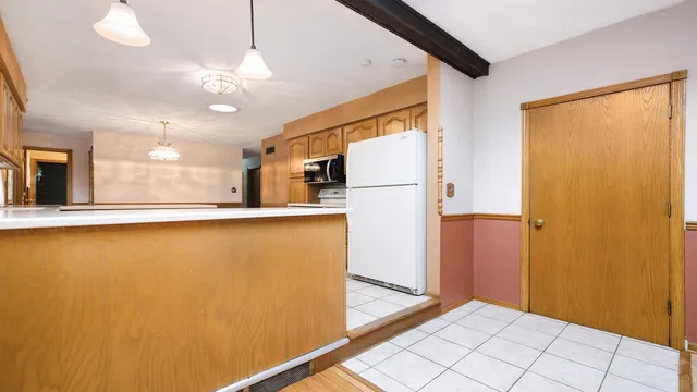a view of empty room with wooden floor and fireplace