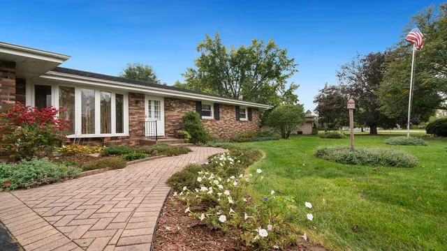 a front view of house with yard and green space