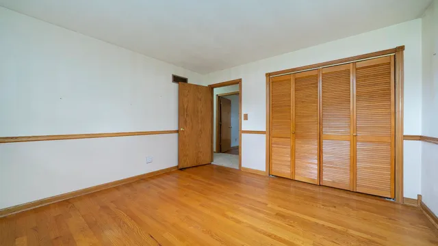 a bathroom with a sink a toilet a mirror a vanity and bathtub