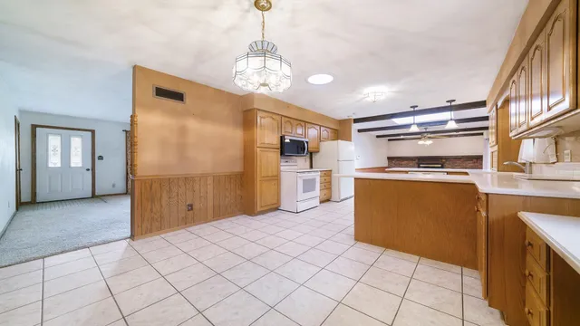 a kitchen with cabinets and chairs