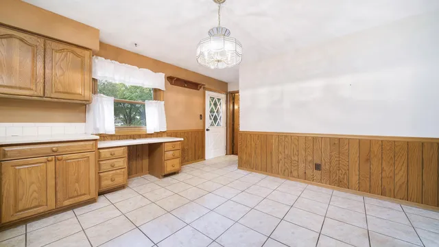 a kitchen with a sink window and cabinets