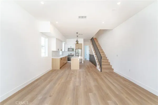 a kitchen with a refrigerator sink and cabinets
