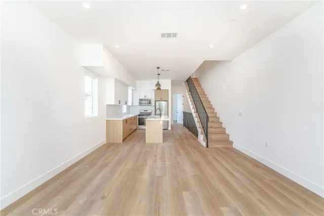 a kitchen with a refrigerator sink and cabinets