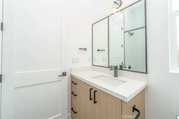 a bathroom with a tub shower and vanity