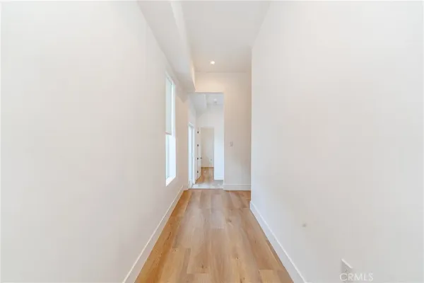 a view of a hallway with wooden floor