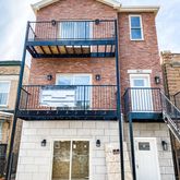 a view of a brick house with many windows