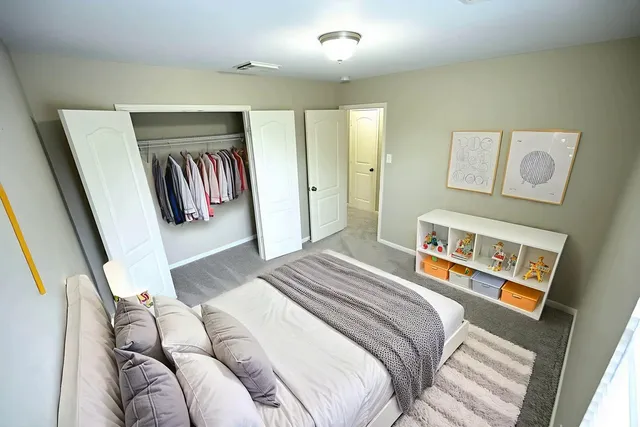 a bedroom with a bed and a window