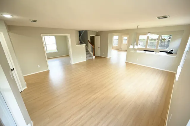 wooden floor in an empty room with a window